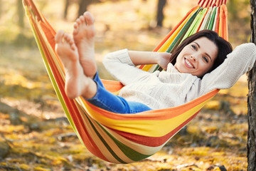 Woman Relaxing on a hammock. Warm autumn