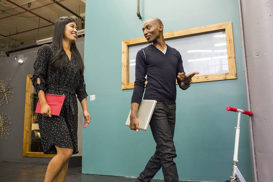 Smiling business people walking in office