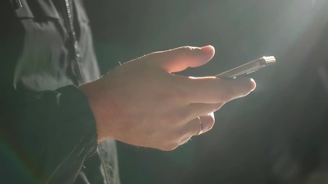 Phone in male hands close-up with glare from the sun. slow motion. 1920x1080. full hd
