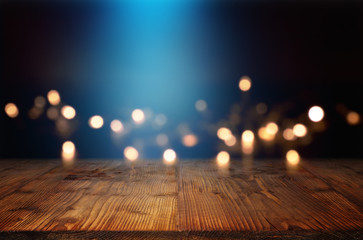 Bokeh background with blue light beam and a wooden table