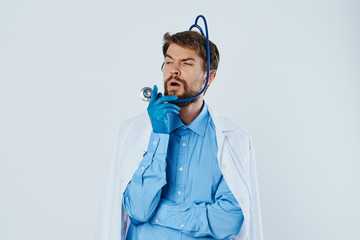 Man with a beard against a light background, medicine, stethoscope, doctor