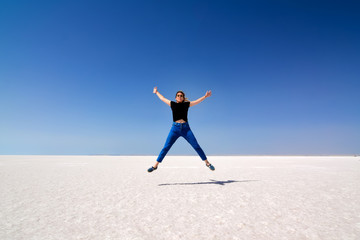 On the salt lake, the happy young girl.