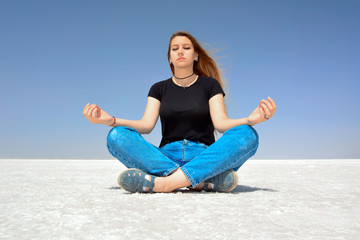 Fototapeta na wymiar On the salt lake, Young woman meditate.