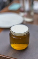 Pot of blond beer close up on a wooden table
