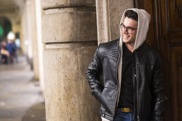 Smiling Caucasian man standing near door