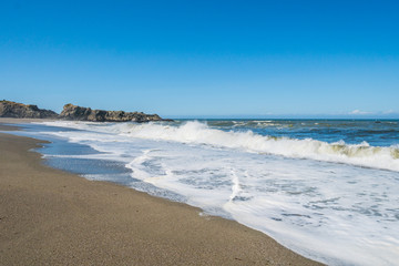 Fototapeta na wymiar A huge sandy beach with large stones. Sonoma Coast State Park, California, USA