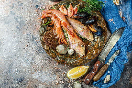 Seafood with lemon, knives, seashells