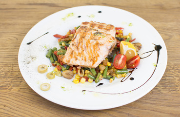 Grill chicken breast. Grilled vegetables with chicken breast. Grilled chicken with vegetables on oak table.