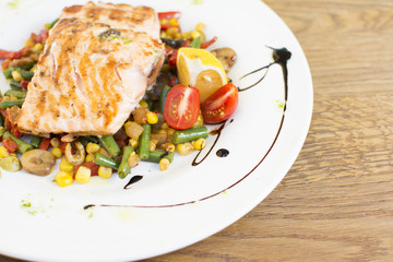 Grill chicken breast. Grilled vegetables with chicken breast. Grilled chicken with vegetables on oak table.