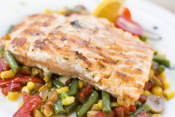 Grill chicken breast. Grilled vegetables with chicken breast. Grilled chicken with vegetables on oak table.