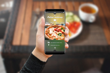 Man hand with phone in restaurant, ordering food online