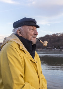 Senior fisherman smoking pipe