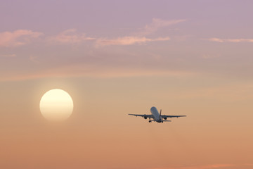 Fototapeta na wymiar Airplane Taking Off and Sunset