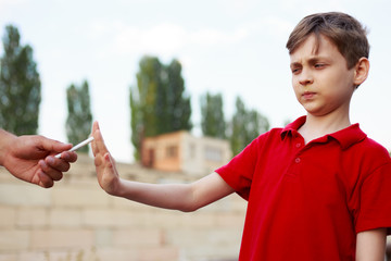 Stop smoking for children. Schoolboy refuse the proposed cigarette. Bad habits, healthcare, quit...