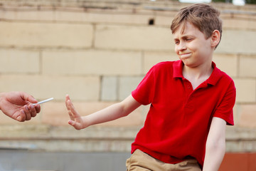 Stop smoking for children. Schoolboy refuse the proposed cigarette. Bad habits, healthcare, quit...