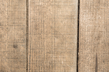 Dark texture of old natural wood with cracks from exposure to sun and wind