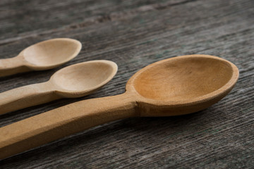 Handmade wooden spoons on a wooden board, kitchen tools
