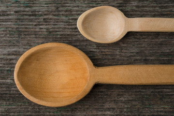 Handmade wooden spoons on a wooden board, kitchen tools