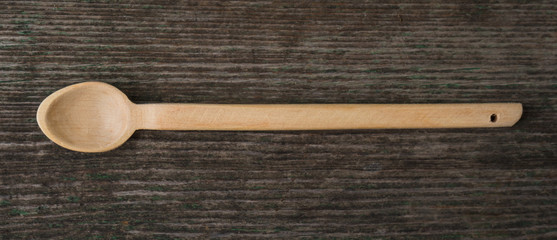 Handmade wooden spoons on a wooden board, kitchen tools