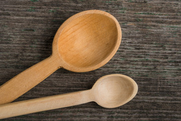 Handmade wooden spoons on a wooden board, kitchen tools