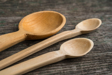 Handmade wooden spoons on a wooden board, kitchen tools