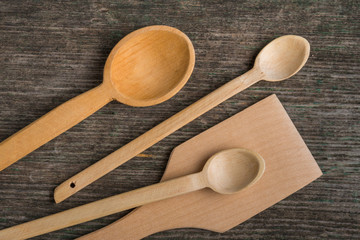 Handmade wooden spoons on a wooden board, kitchen tools