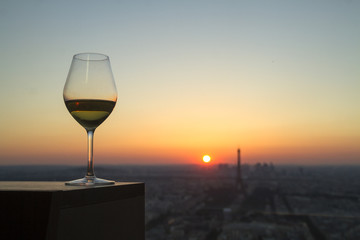 Wine glass with view on paris city at sunset