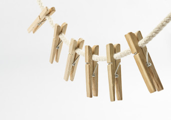 Clothes clips on a rope isolated on white background