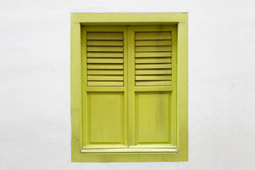 Fototapeta na wymiar Green wooden window is classic vintage style on white cement wall background.