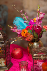 A table set vase with flowers decorate in purple and pink