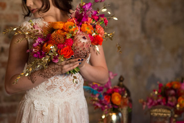 woman in wedding dress holding beutiful bouqet in hand