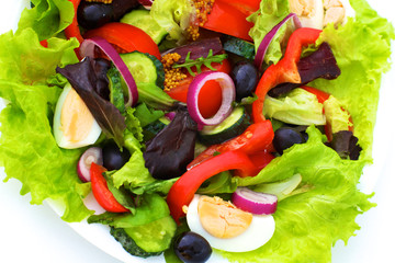 salad from fresh vegetables in a plate on a table, selective focus