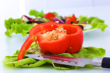 salad from fresh vegetables in a plate on a table, selective focus