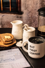 But First Coffee with market report on tablet,  toast, milk, sugar, vertical