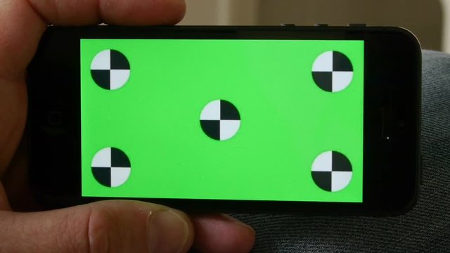 Smart Phone held by hands. Green screen Chroma Key. Close up. Tracking motion. Horizontal.