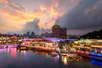 Fototapeta premium Colorful light building at night in Clarke Quay, Singapore. Clarke Quay, is a historical riverside quay in Singapore.