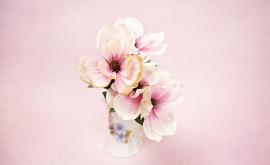 Fototapeta na wymiar Beautiful White and Pink Silk Flowers on a Pink Background