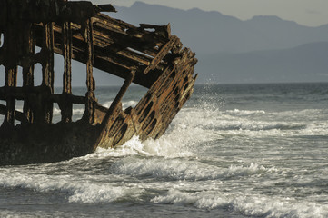 Ocean crashing on Skeleton of Ship Wreck