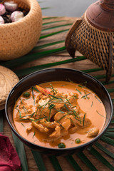 Red Curry with pork on wooden table, Thai food.