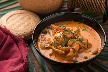 Red Curry with pork on wooden table, Thai food.