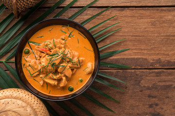 Red Curry with pork on wooden table, Thai food.