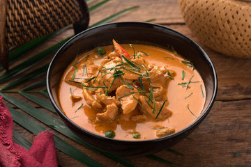 Red Curry with pork on wooden table, Thai food.