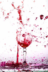 red wine splash in the glass on white background,red water drop splash on white background