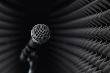 Microphone at black studio sound acoustical foam Background