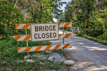 Bridge Closed Sign has been moved to the side of the road and now the bridge is both closed and open causing confusion