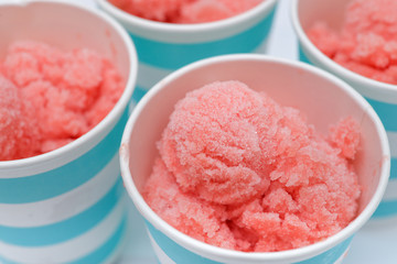 Homemade watermelon sorbet in blue paper cup