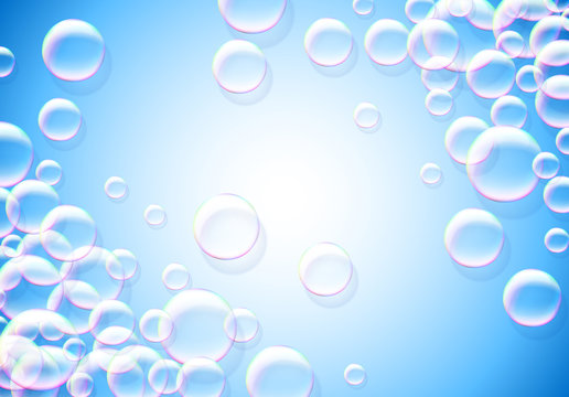 Soap bubbles abstract blue background with rainbow colored airy foam