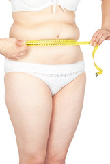 Fat woman measuring her stomach