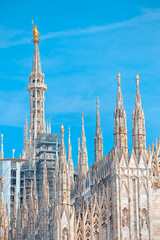 Fototapeta na wymiar Details of the Milan Cathedral, the spiers and the Madonna