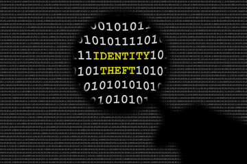 Hand Holding Magnifying Lens Over Binary Code And Text